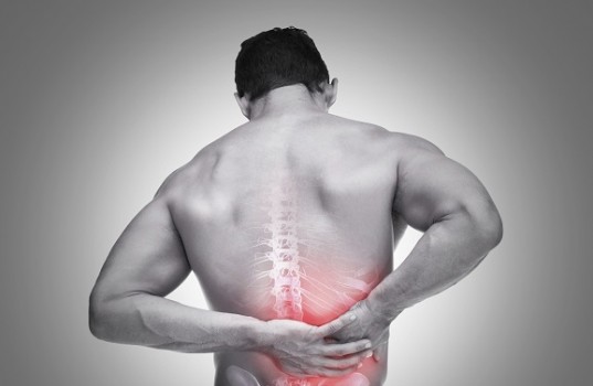 Young man suffering from back pain